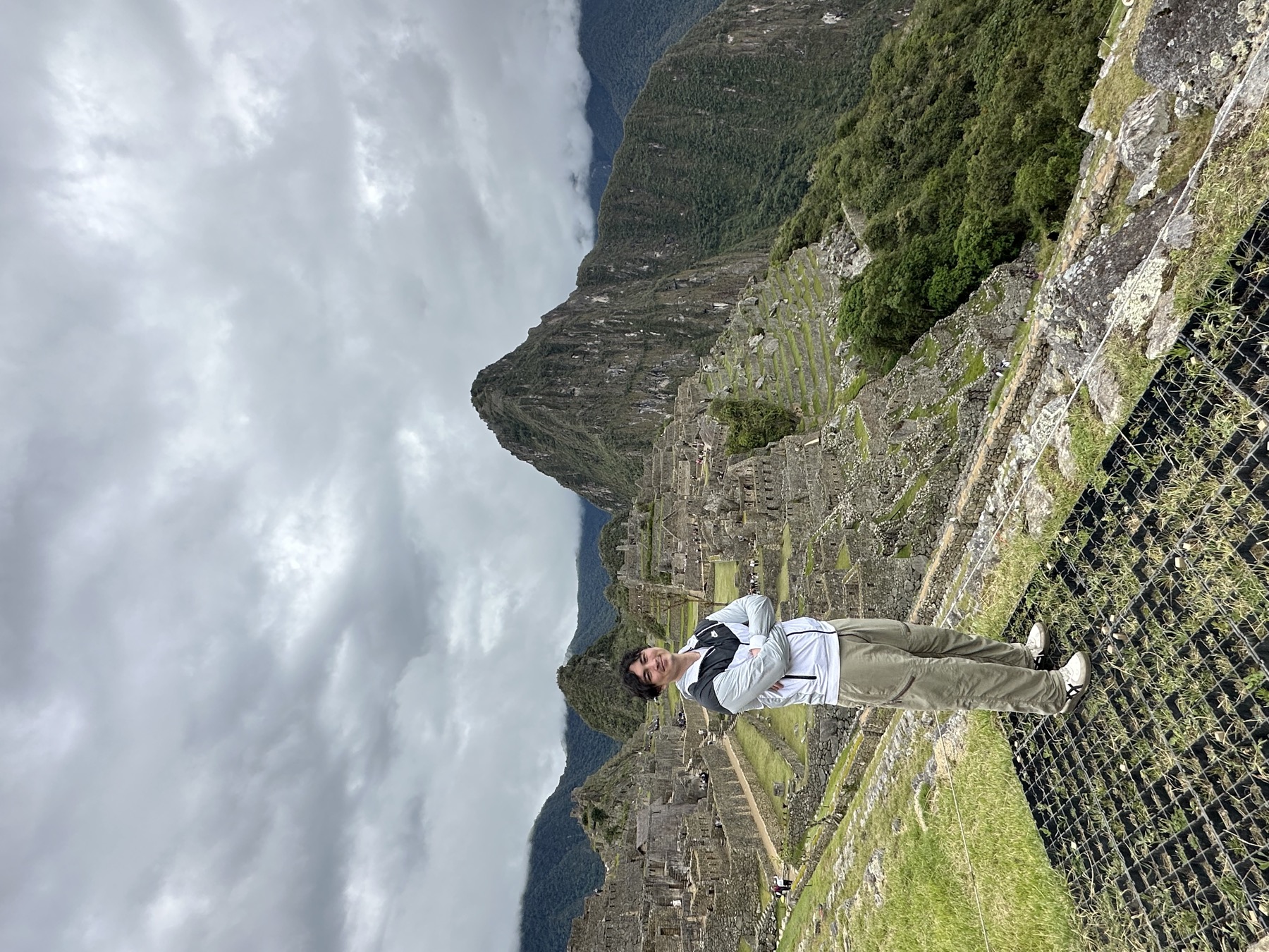 Nate standing above the stone terraces of Machu Picchu with Huayna Picchu rising behind
